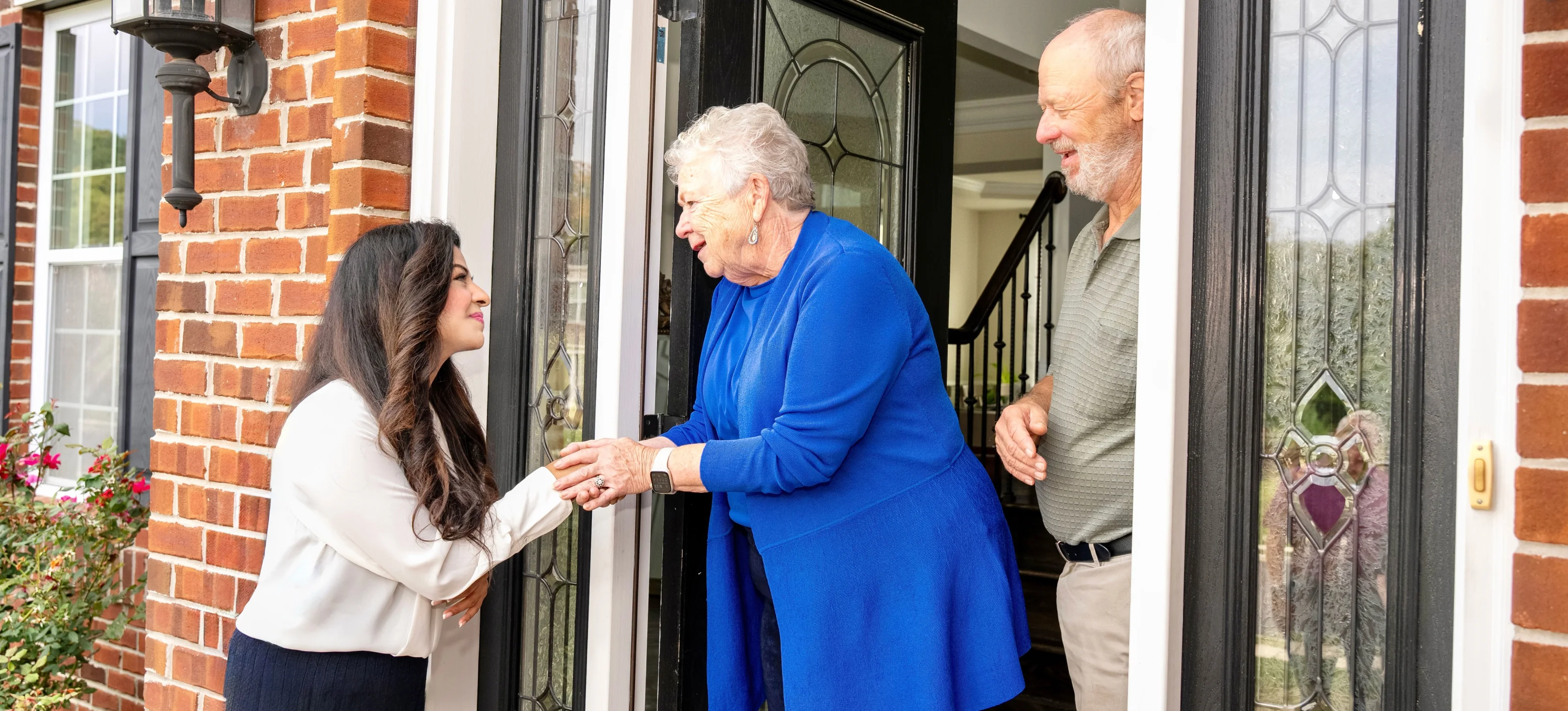 Meriam Sabih greeting neighbors at their front door